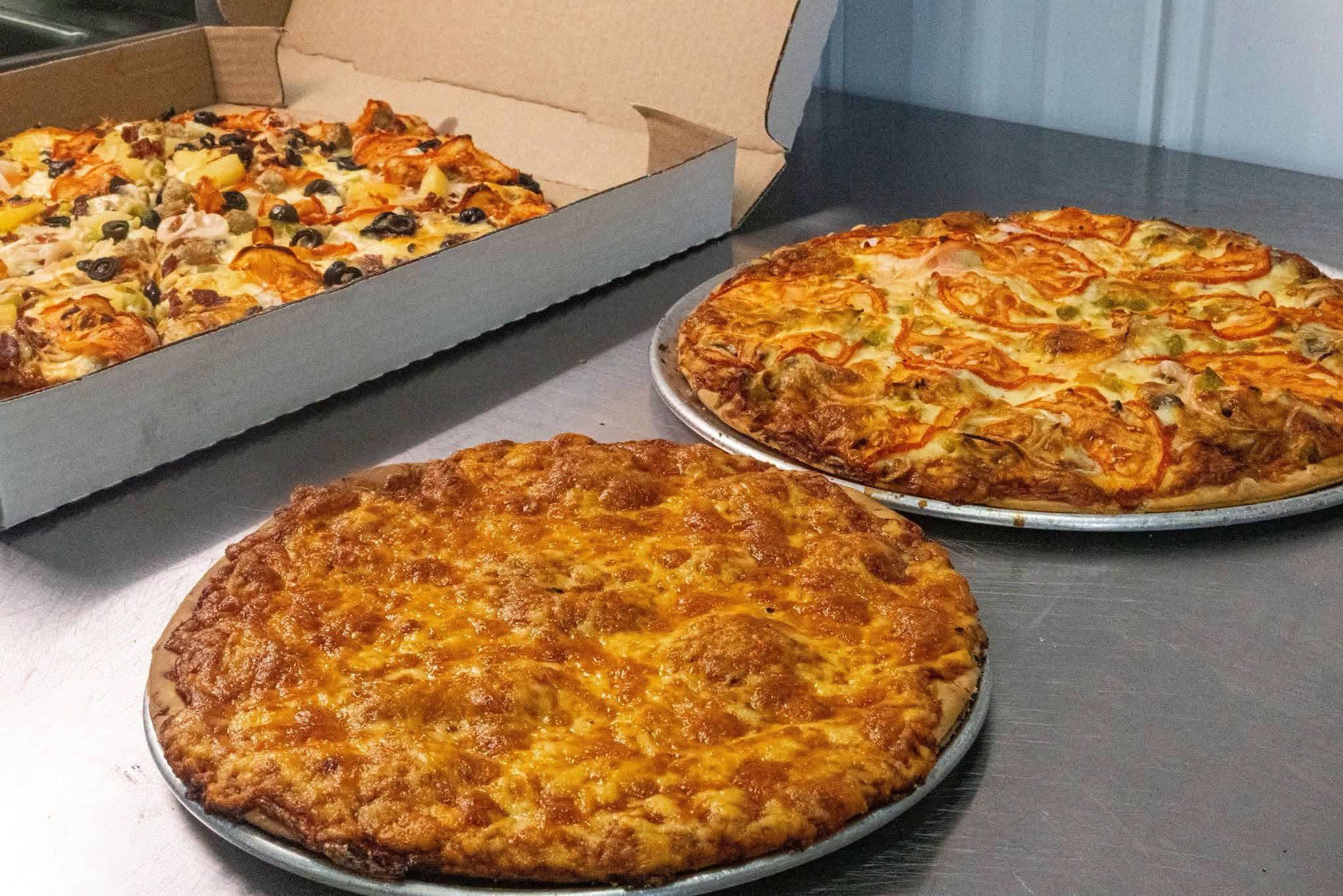 Three different Salty’s pizzas freshly prepared