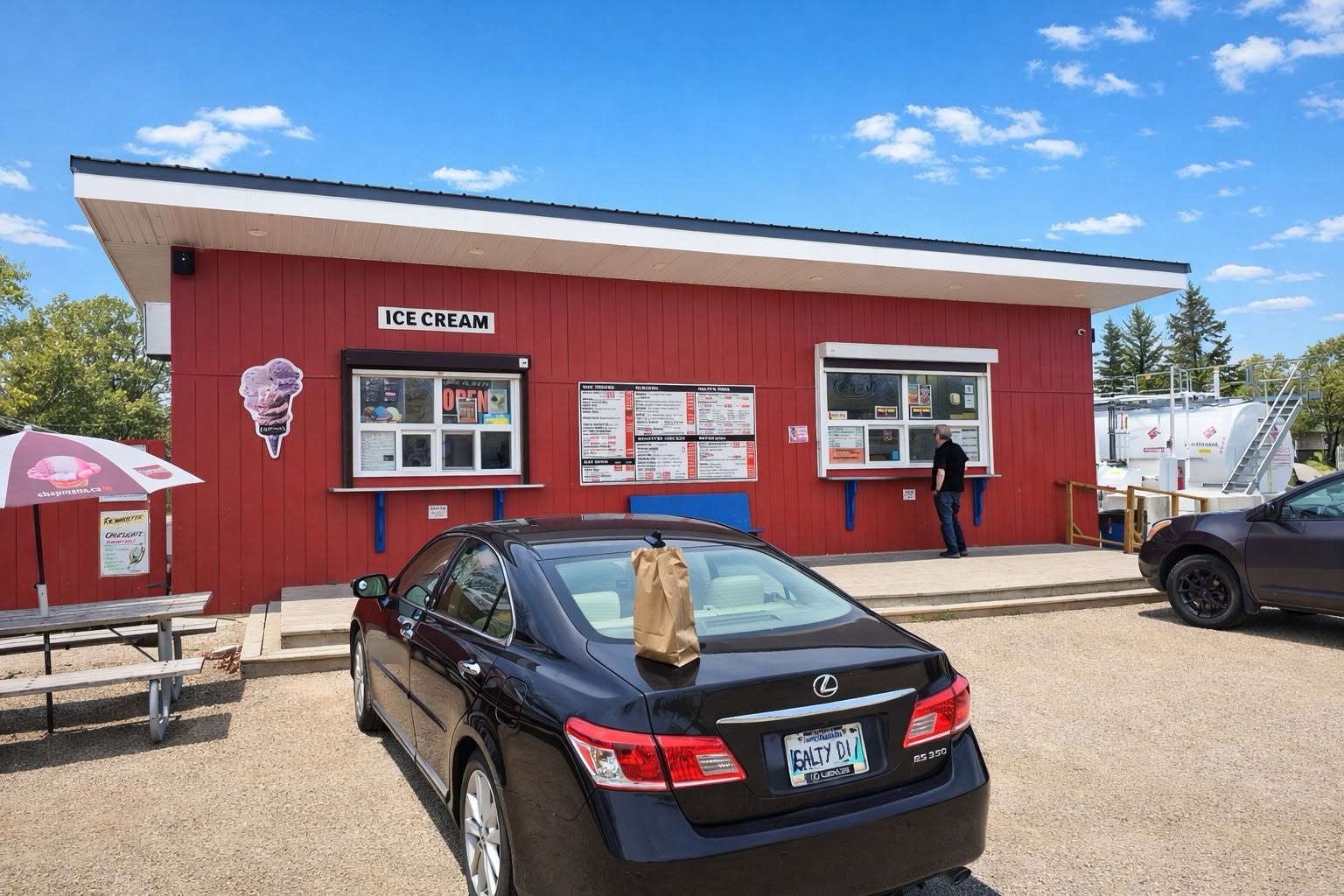 Salty’s red drive-in building, ice-cream window and outdoor seating in Winnipeg Beach